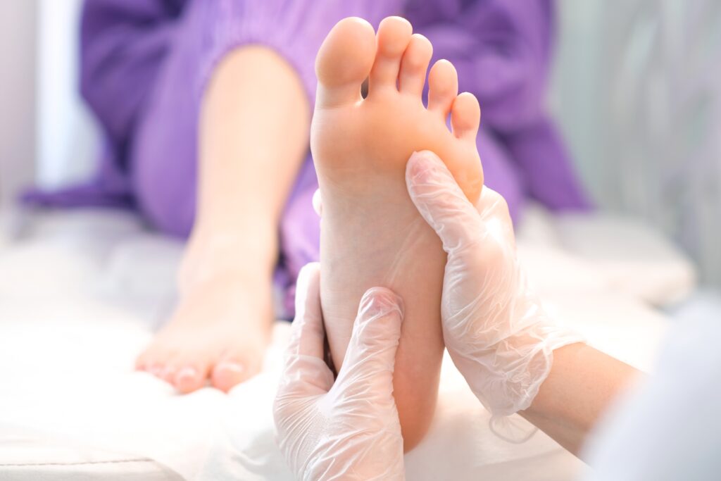 medical,pedicure.,foot,massage,with,hands,in,transparent,gloves.